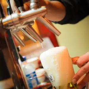 bartender pouring a beer at bar near apartment in wilmington de