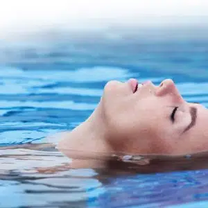 woman relaxing in pool at apartment in wilmington de