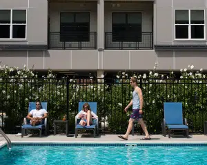 people lounge by pool at apartments in wilmington de