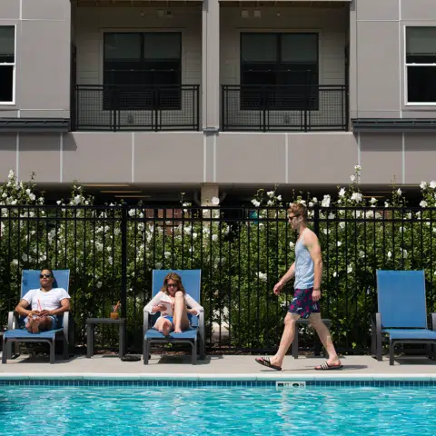 people lounge by pool at apartments in wilmington de