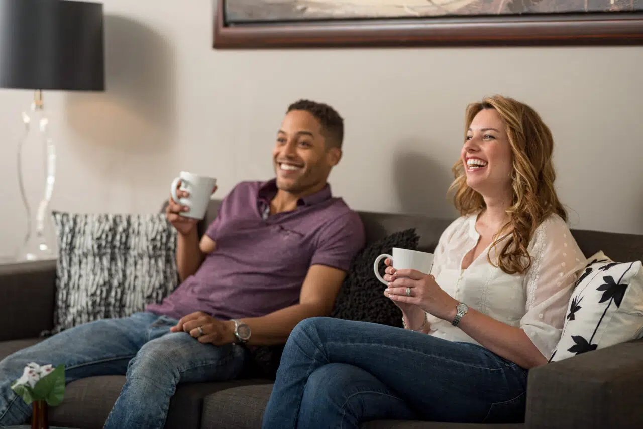 Couple in living room at Harlan Flats apartments in Wilmington Delaware